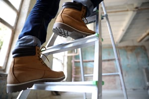 Tradesperson climbing a ladder